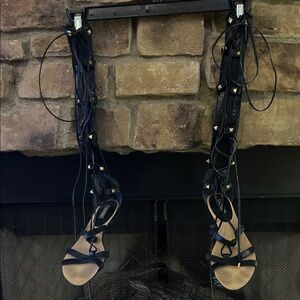 Guess Black Gladiator lace up Sandals in front and zipper in back.